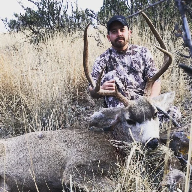 Hunter celebrating a successful guided hunt with Hook N 30 Outfitters