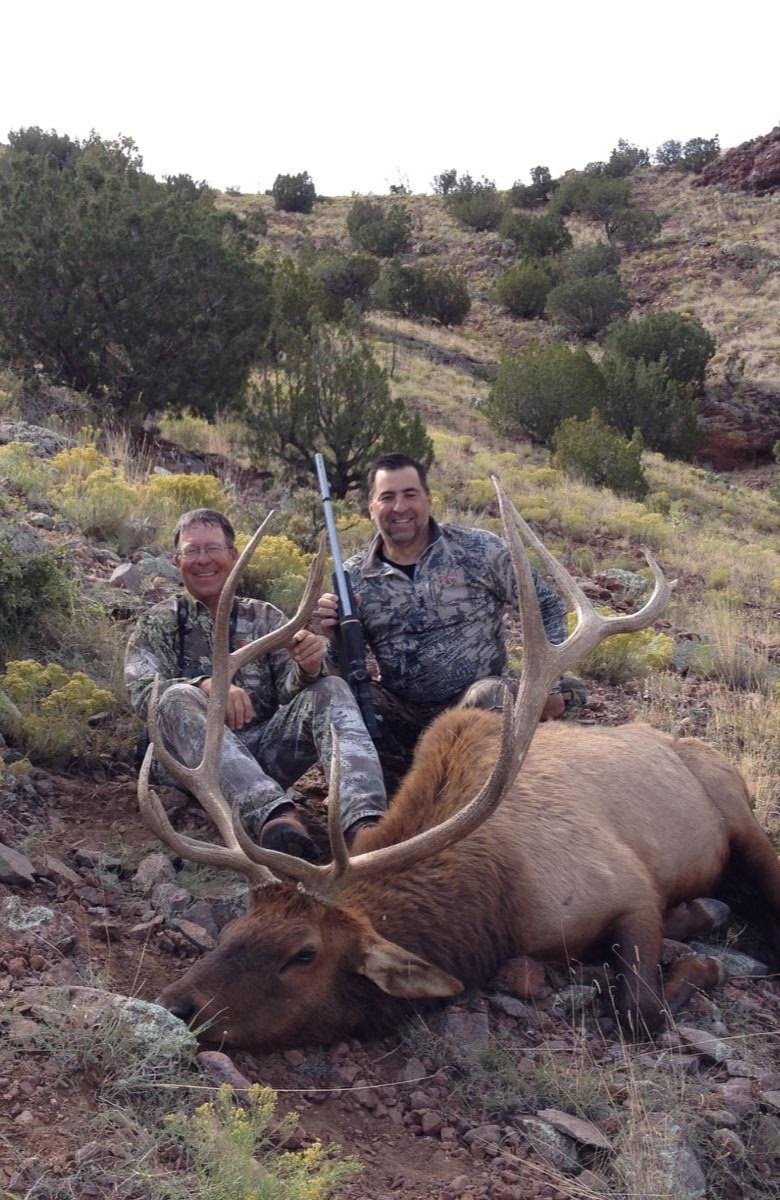 Hunter and guide posing with a trophy bull elk from a Hook N 30 Outfitters hunt in New Mexico.