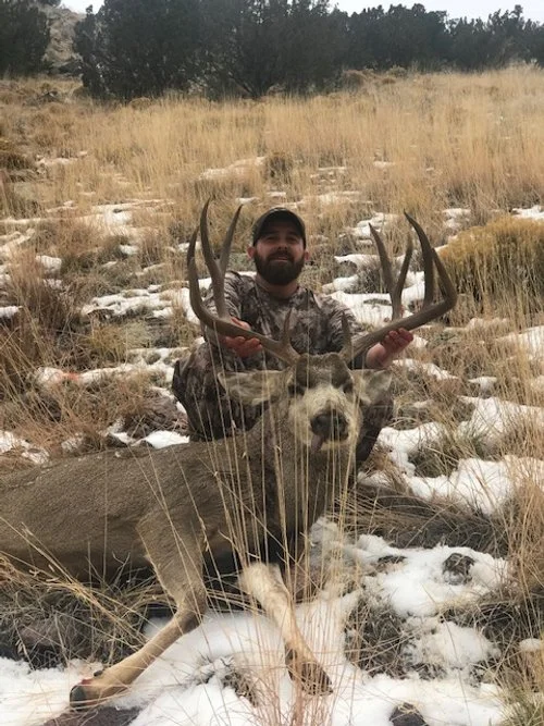 Hunter celebrating a successful guided hunt with Hook N 30 Outfitters