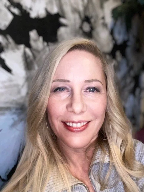 A logo for Loveland Community Yoga featuring a lotus flower and mountain background, with the words "movebreathe.co/connect" encircling the design.