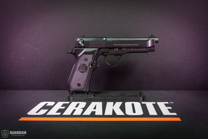 A semi-automatic handgun displayed on a black surface with 'CERA KOTE' written in bold white letters.