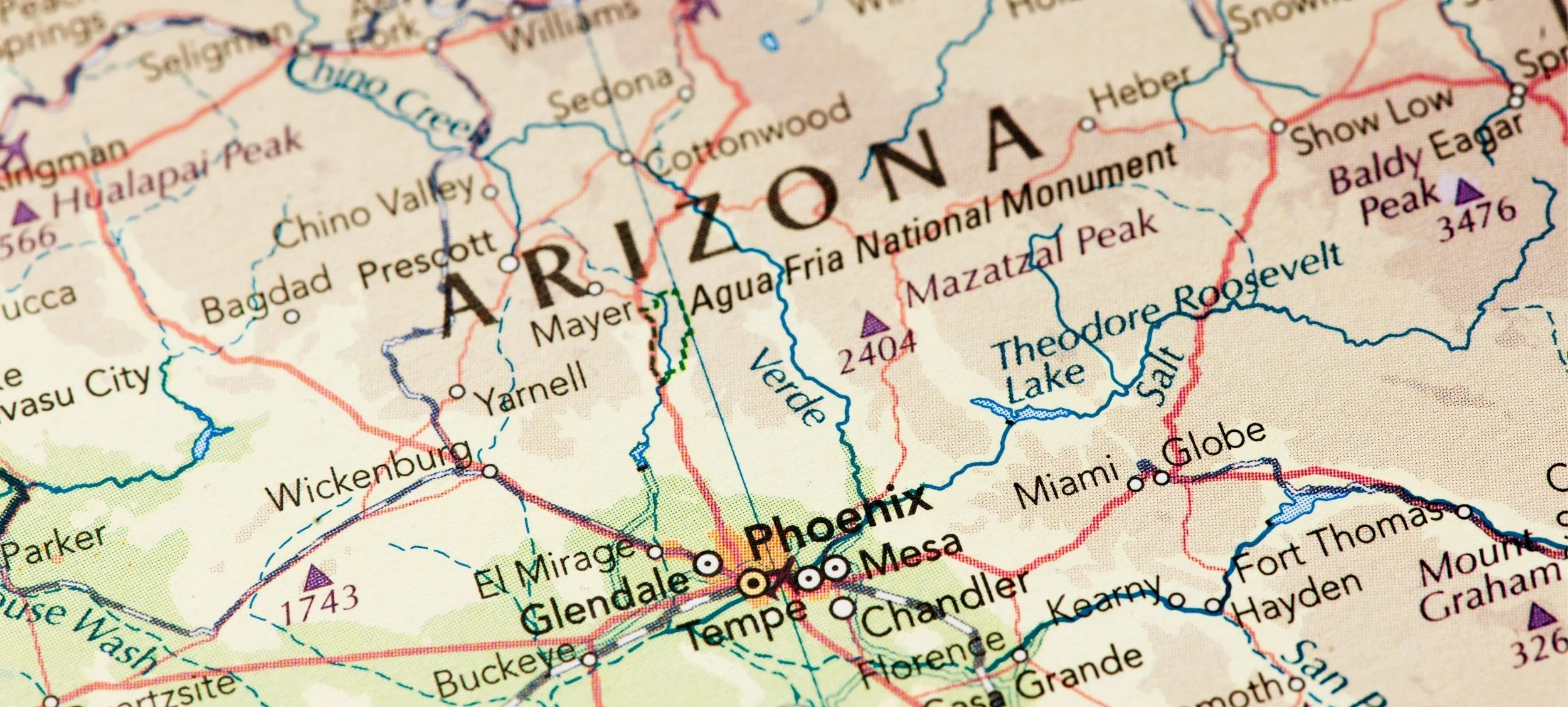 A detailed map of Arizona highlighting cities such as Phoenix, Tucson, Flagstaff, and others, with mountain ranges, lakes, and roads marked.