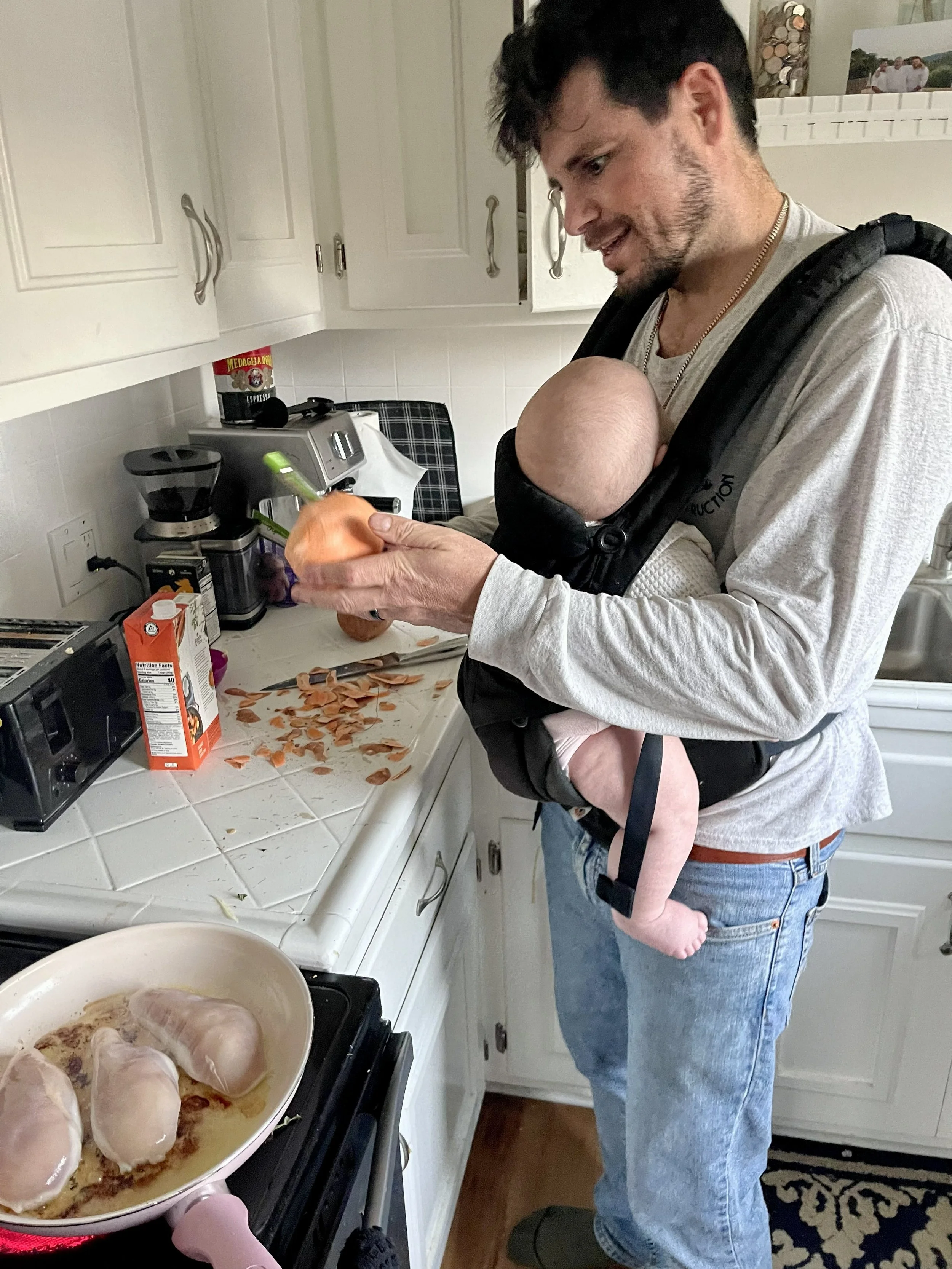 Early days cooking with my daughter on my chest