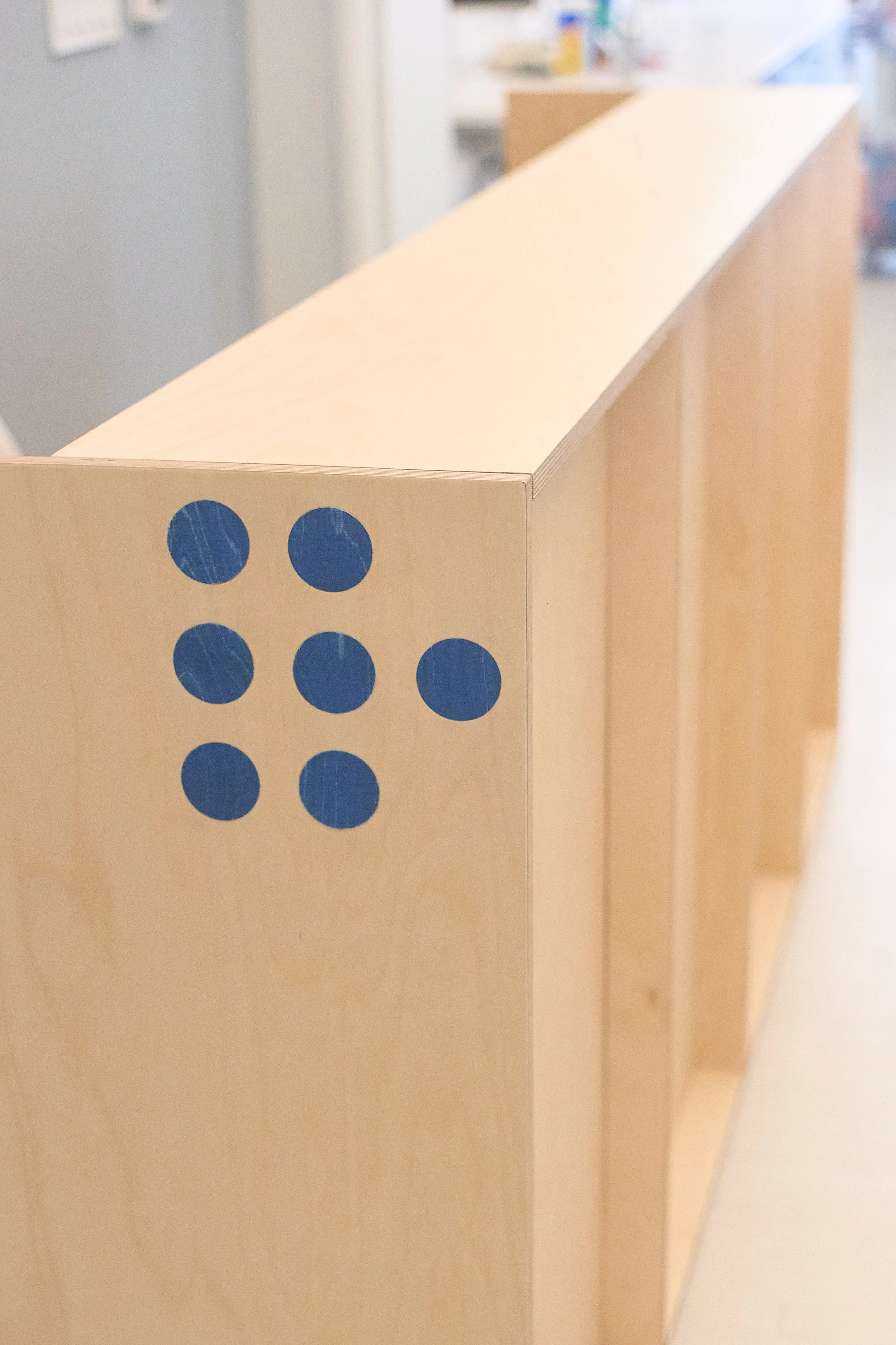 Plywood reception desk side view showing construction quality.