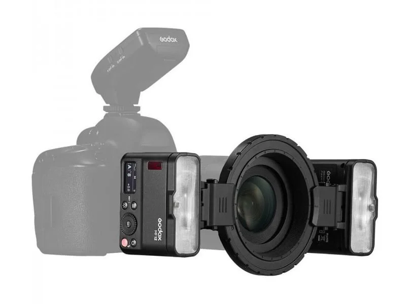 Camera with a large lens and dual flash units, with a ghosted remote flash in the background.