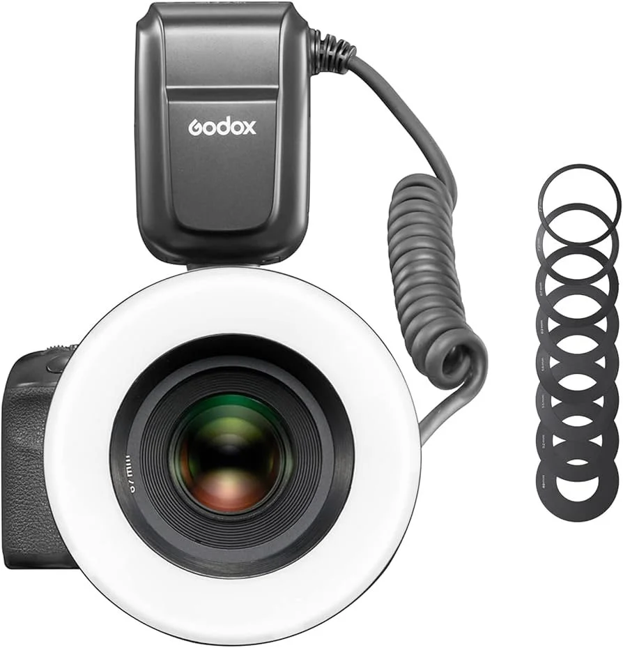 Camera with a flash diffuser, coiled cord, and circular filters.