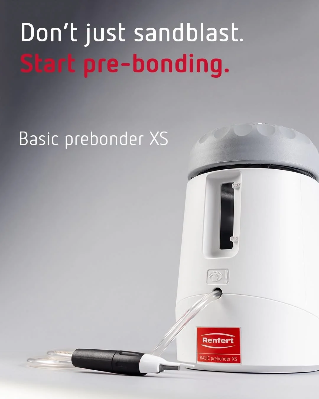 An automatic appliance called a basic prebonder XS used for pre-bonding in sandblasting processes, shown on a gray surface, with a tube and nozzle attached.