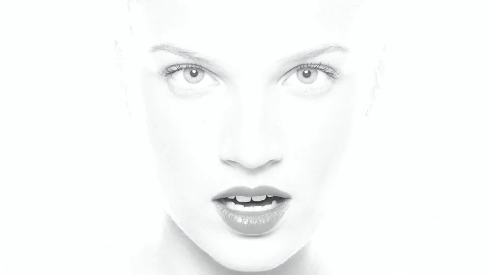 Close-up of a woman's face with an intense expression, high contrast, black and white photography.