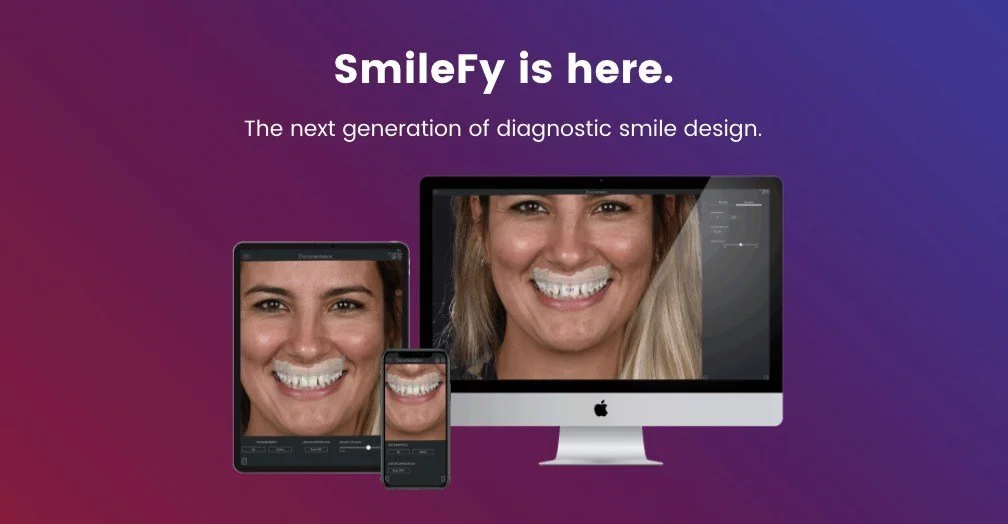The image shows a promotional display for SmileFy, a diagnostic smile design technology, featuring a large computer monitor, a tablet, and a smartphone, all displaying a smiling woman's face.