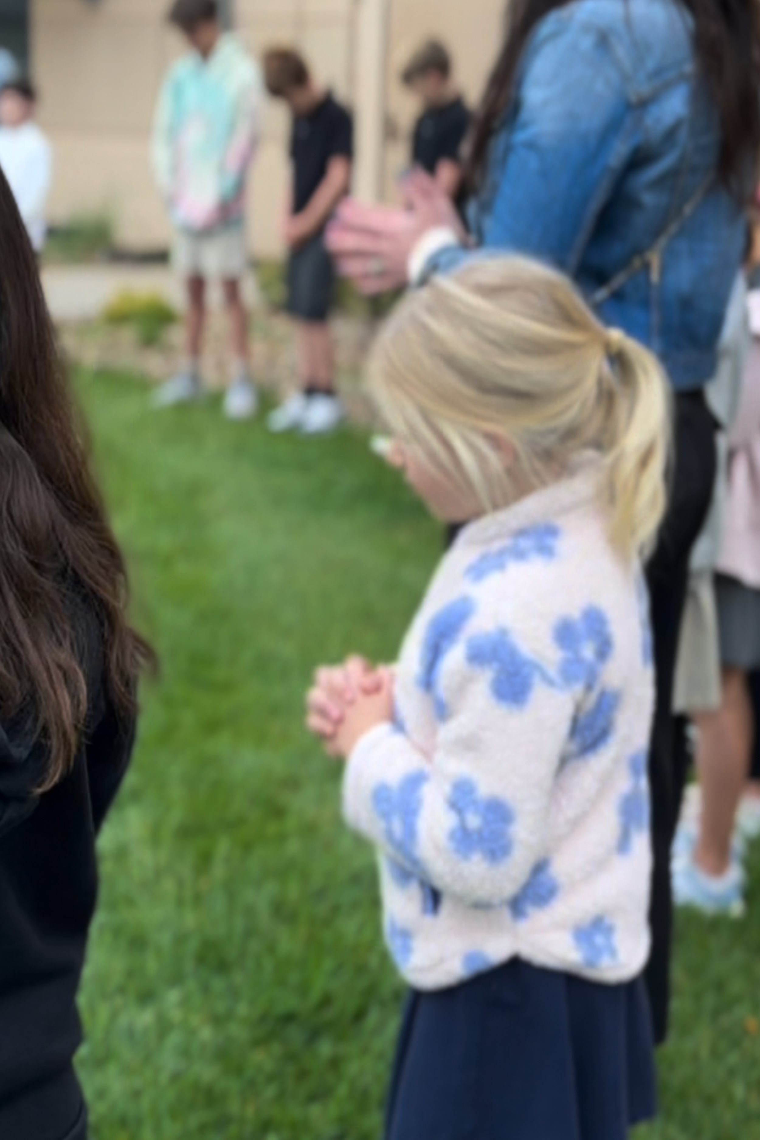 Students Clasping hands in prayer at See you at the pole