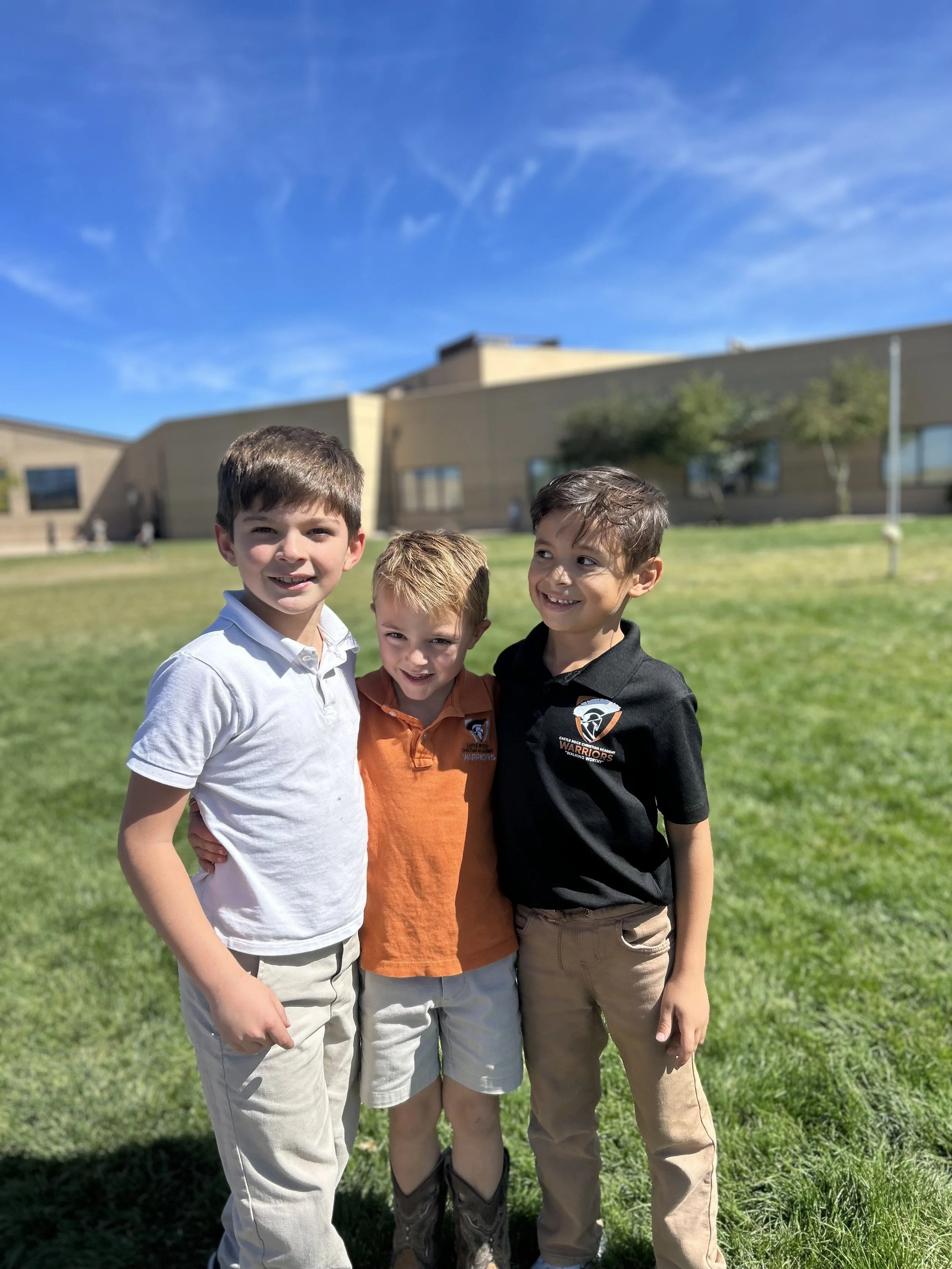 Three CRCA Students Smiling Outside at Recess