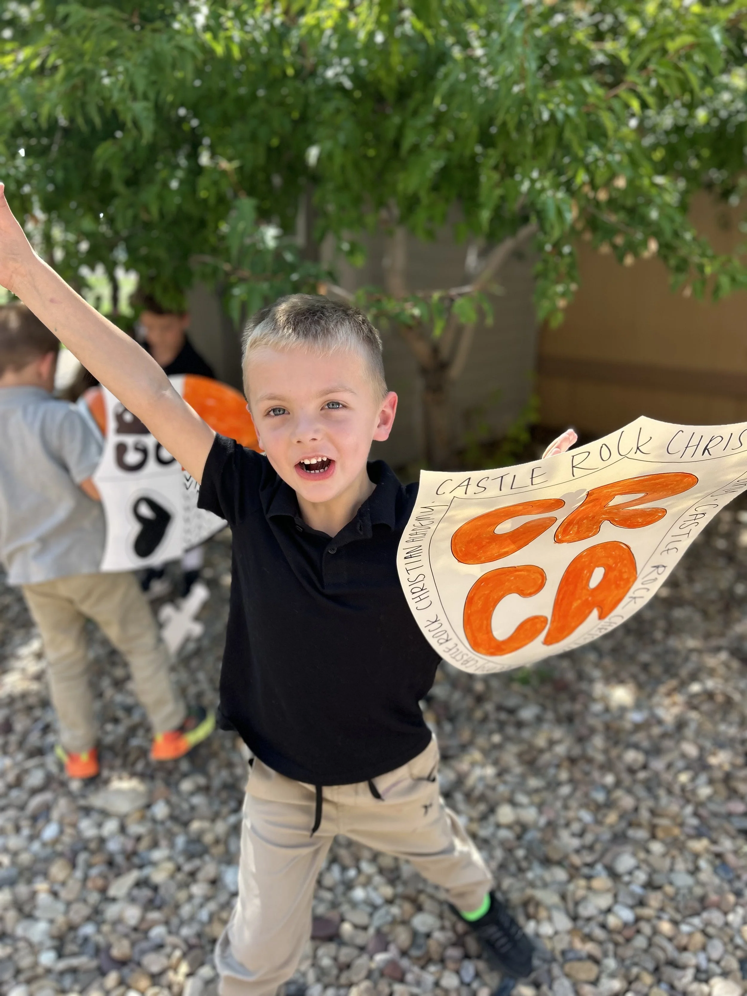 Kindergartener with a paper sword and shield.jpg