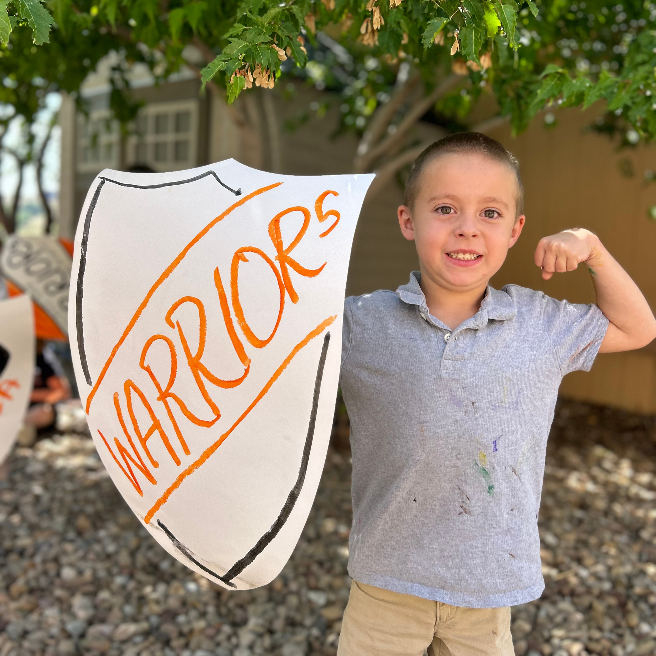 Kindergarten Student posing with Shield