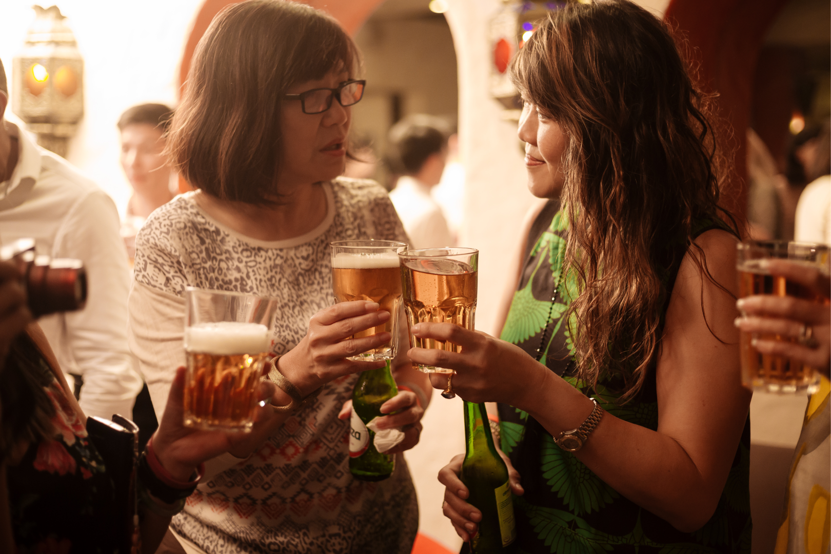 People enjoying drinks and socializing at a party or bar