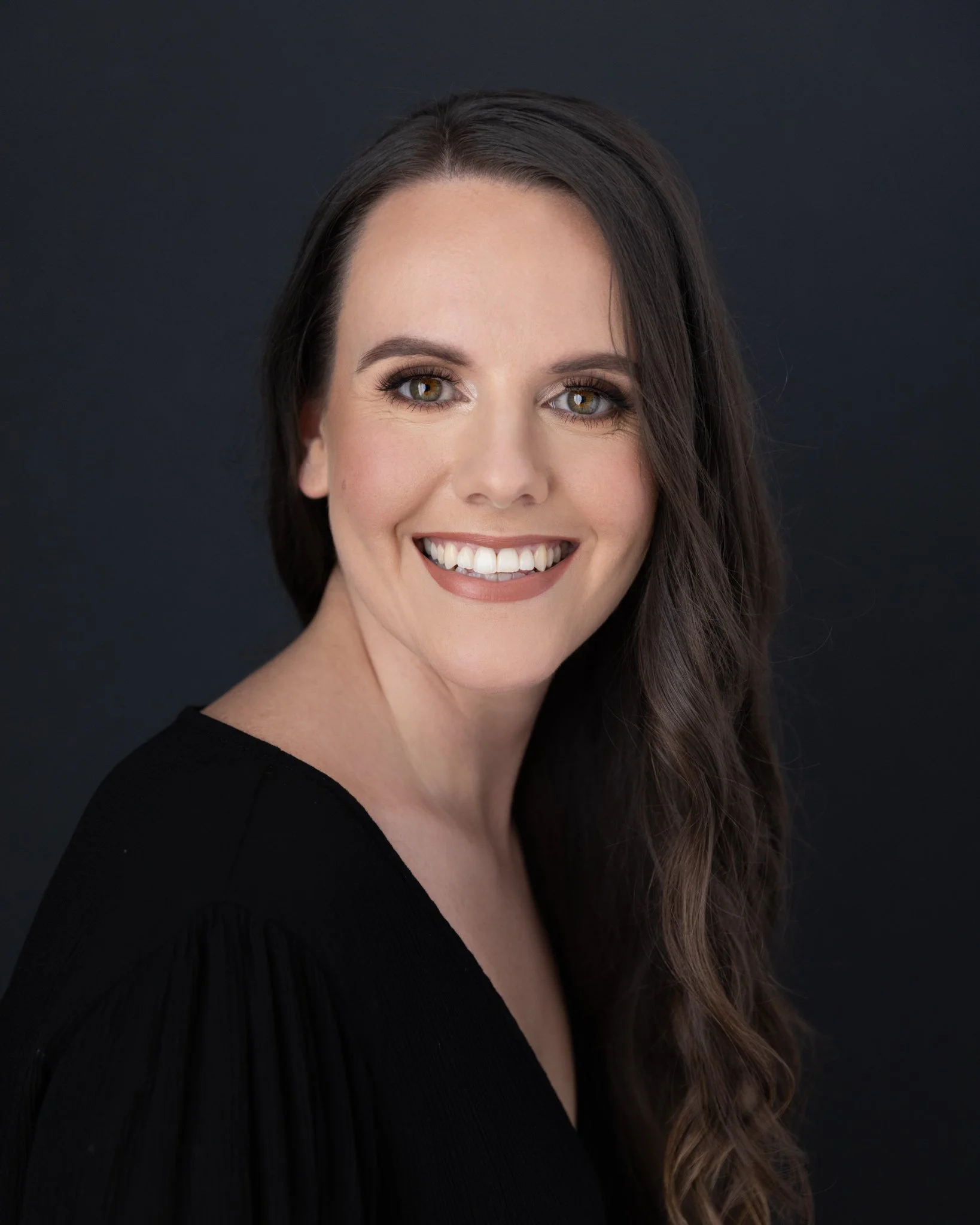 Headshot of a women wearing black top