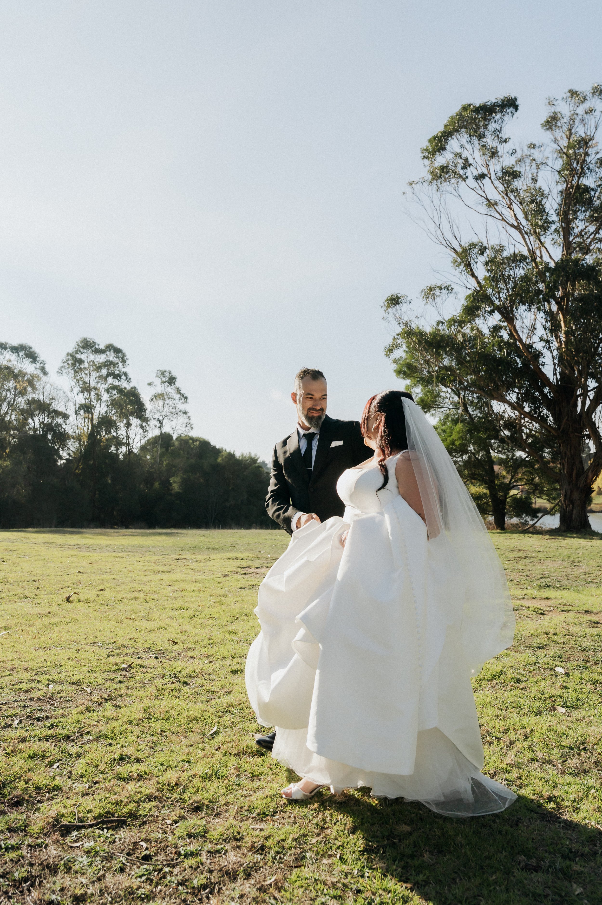 Elegant dining table set with white plates, silverware, napkins, and glasses, set for a meal.