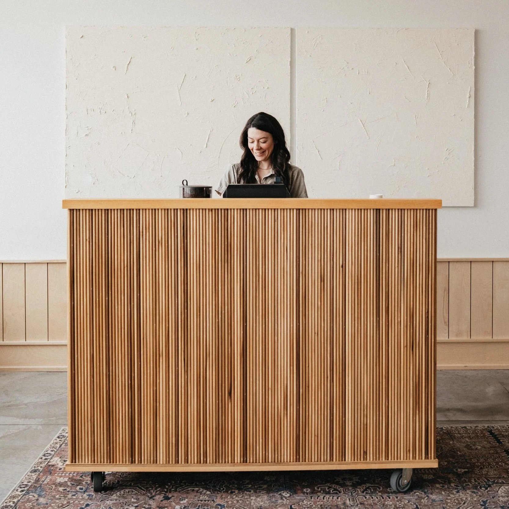 barista creates espresso behind fluted coffee cart