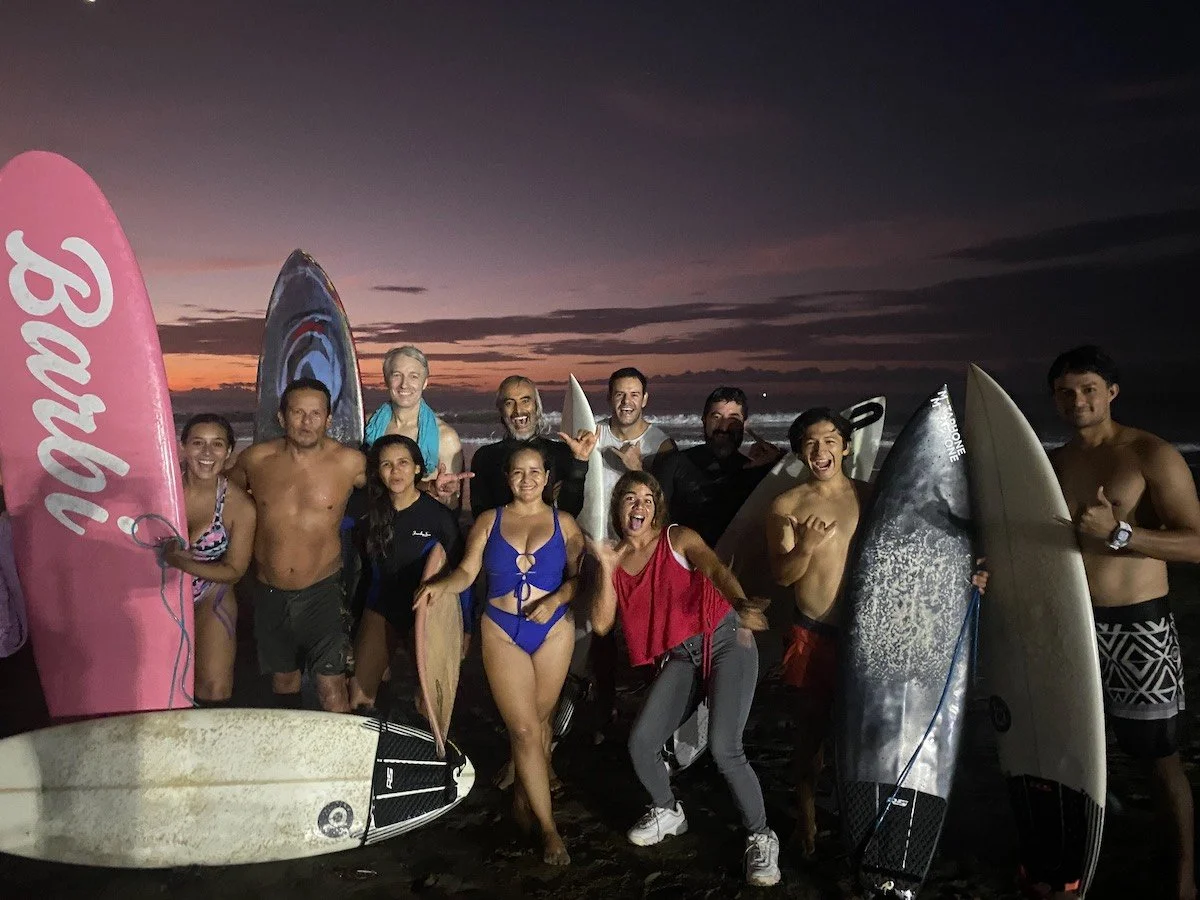 Aaron with friends on a beach in Ecuador