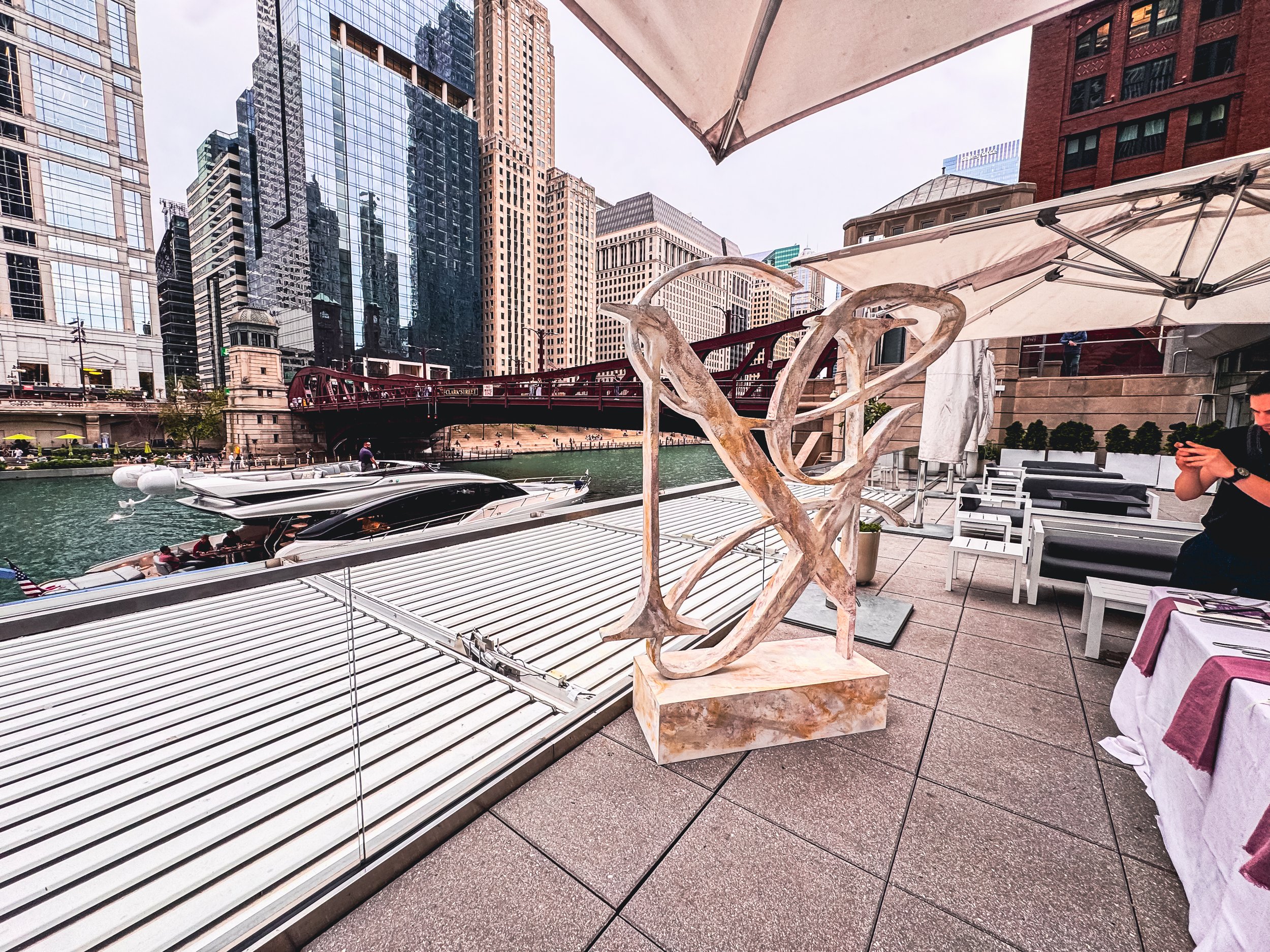 Custom 3D marble-style foam sculpture created by DiverCity Artistry and photographed near the Chicago Riverwalk, RPM events area, luxury venue setting, and downtown skyline.