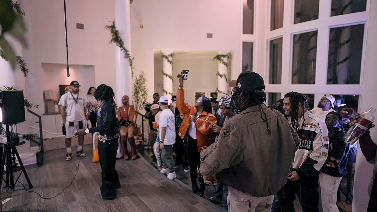 Artist event crowd inside an Austin mansion during independent SXSW-week creative coverage and performance visuals