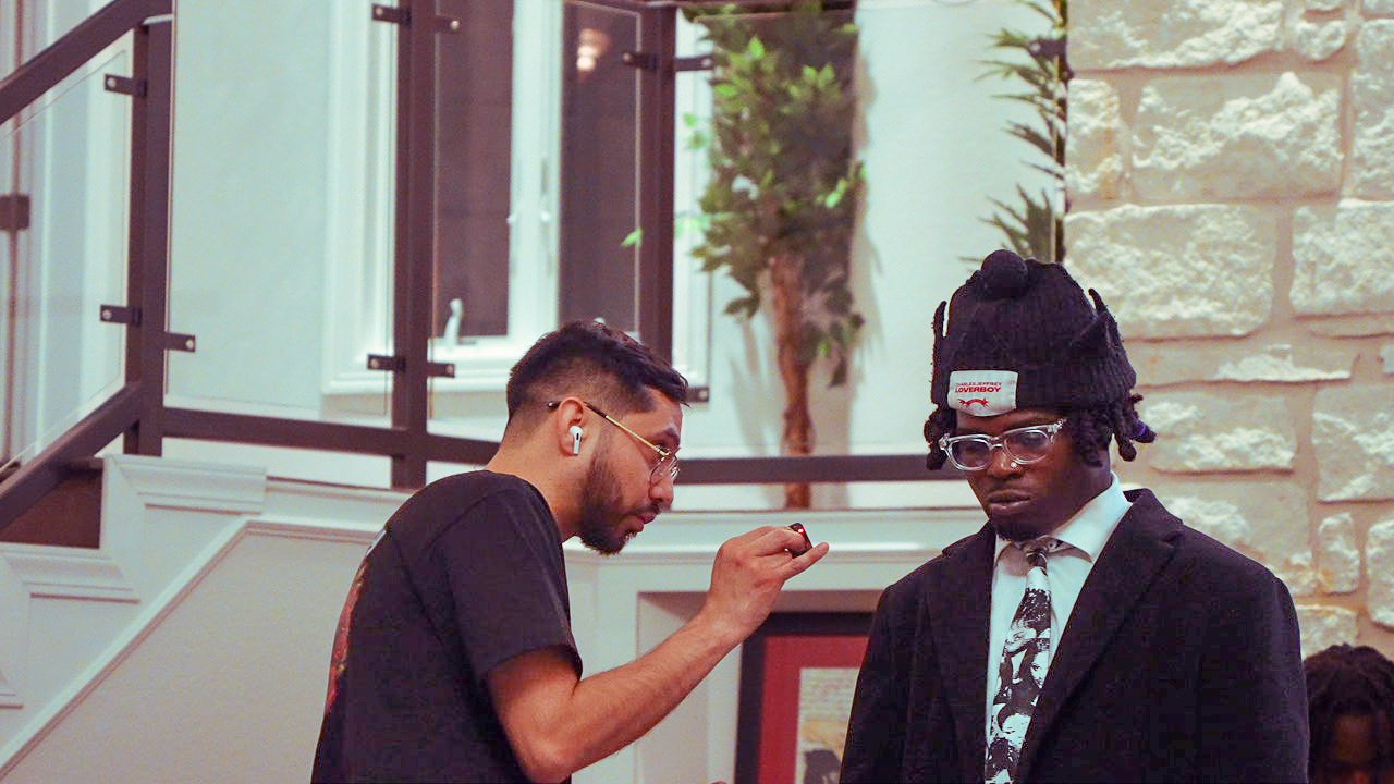DiverCity Artistry coordinating microphone setup and artist prep with Young Deji during an independent Kozy music and content activation in Austin.