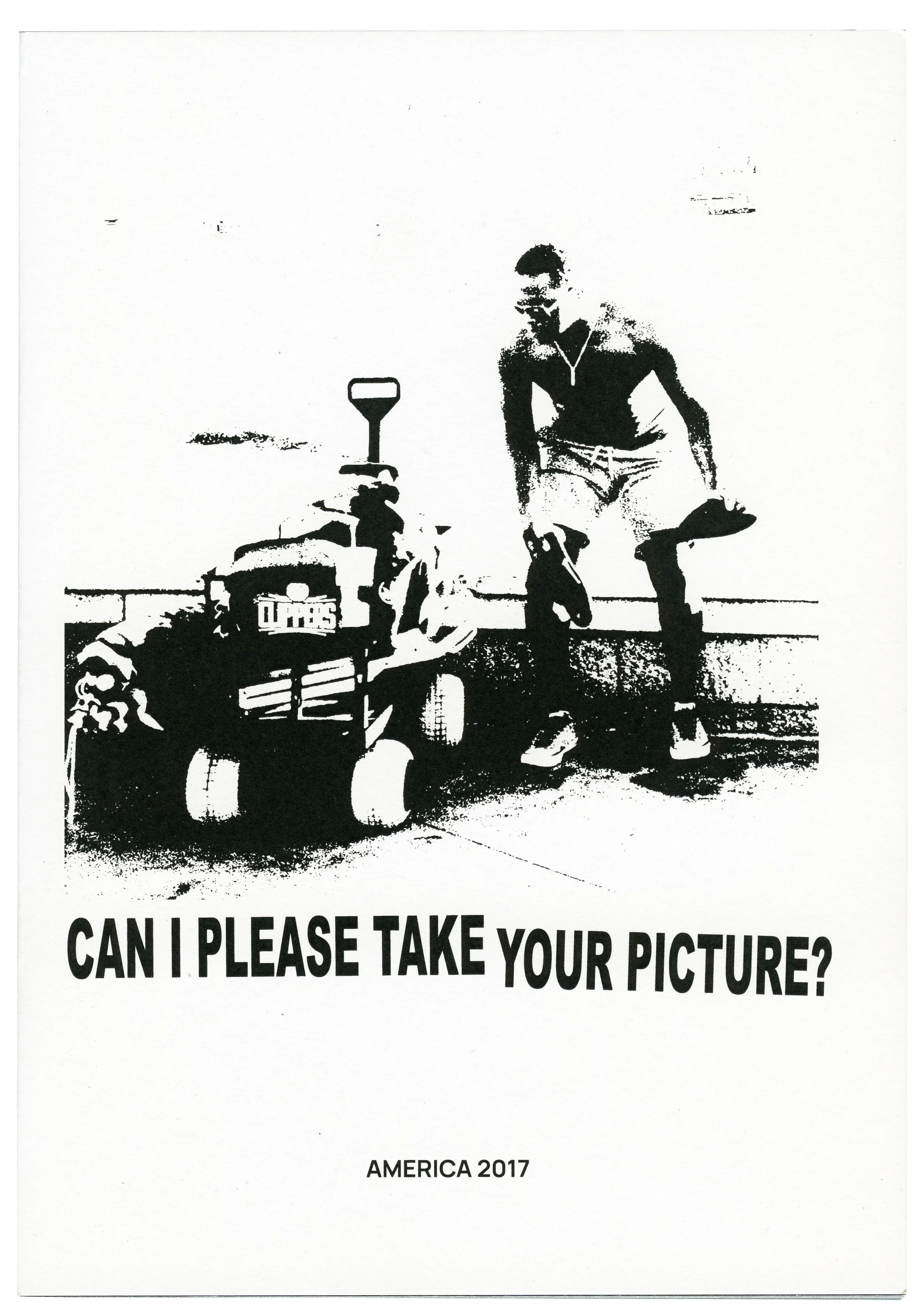 Black and white high-contrast photo of a person with a bicycle, holding a bag, with a sign in the foreground that says 'CAN I PLEASE TAKE YOUR PICTURE?' and text 'AMERICA 2017' at the bottom.