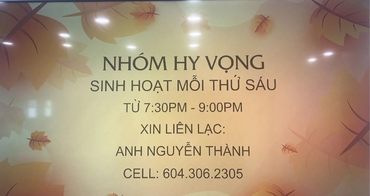 Informational sign with leaf illustrations, text in Vietnamese about a group activity meeting on Fridays from 7:30 PM to 9:00 PM, with contact details.