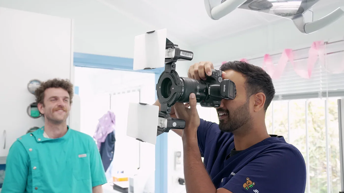 Behind-the-scenes dental videography featuring Dr Janak Patel photographing a patient during a promotional video shoot designed to showcase professional dental services and patient experience.