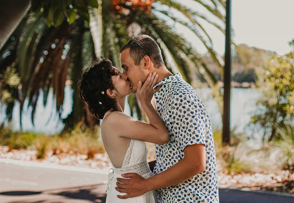 Bride and groom kissing during golden hour wedding photography