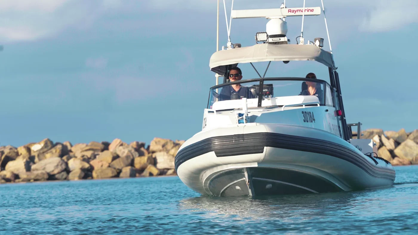 Cinematic recruitment videography capturing fisheries officers operating a patrol boat on the water, showcasing teamwork, field operations and the dynamic nature of the role.