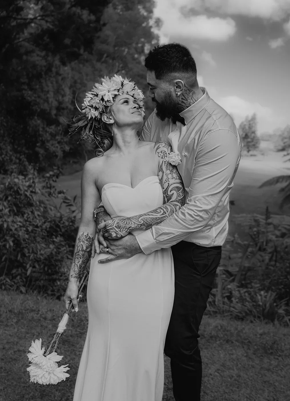 Black and white wedding photography capturing a bride and groom smiling at each other, creating a timeless and intimate portrait filled with natural emotion.