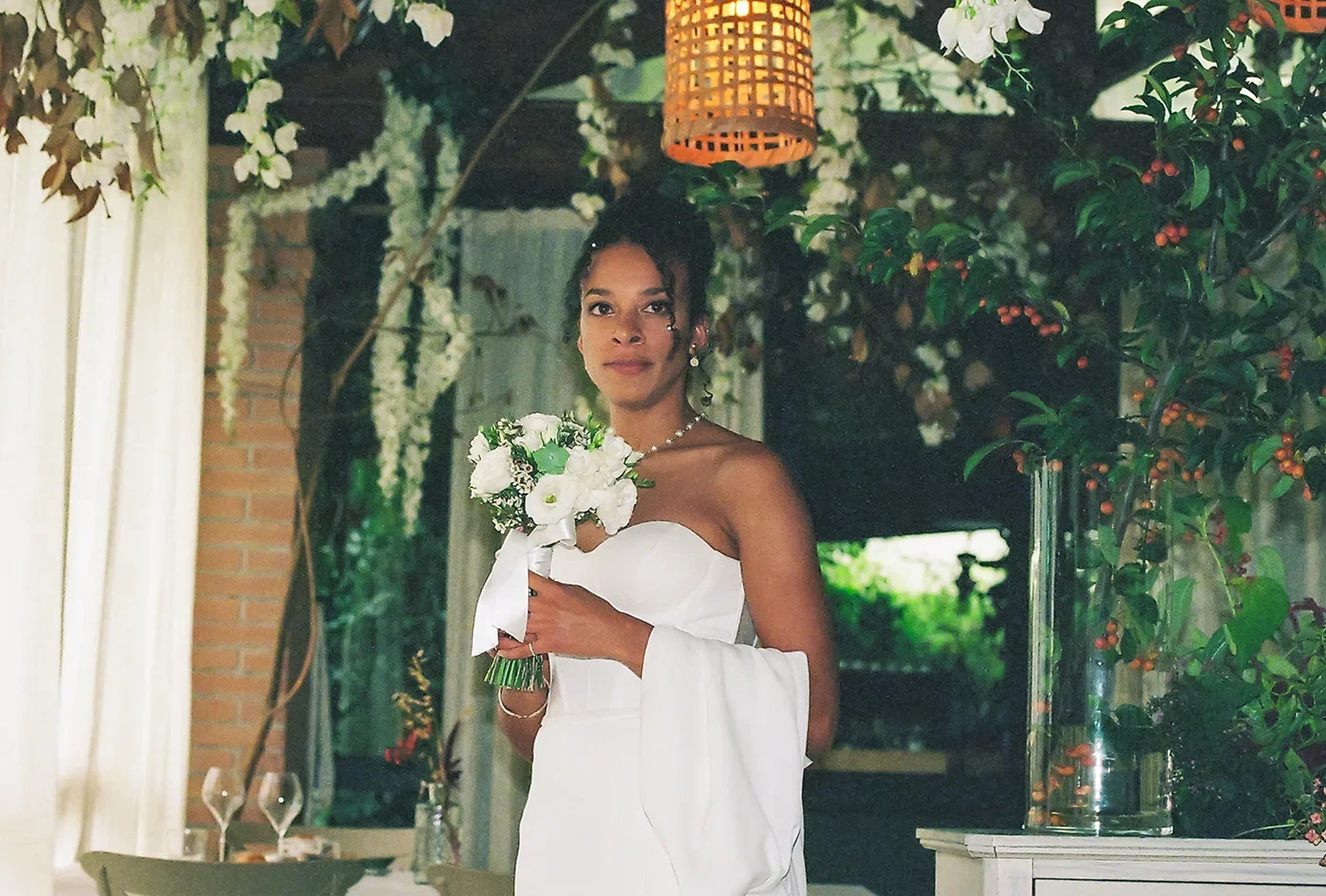 Bride holding wedding flowers during ceremony