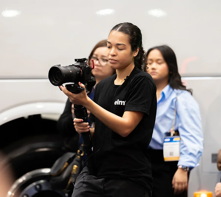 Brisbane videographer operating a camera on a gimbal during a live event, filming smooth, handheld footage for real-time coverage