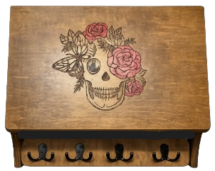 Decorative hidden gun cabinet with skull and floral design for discreet firearm storage in the home
