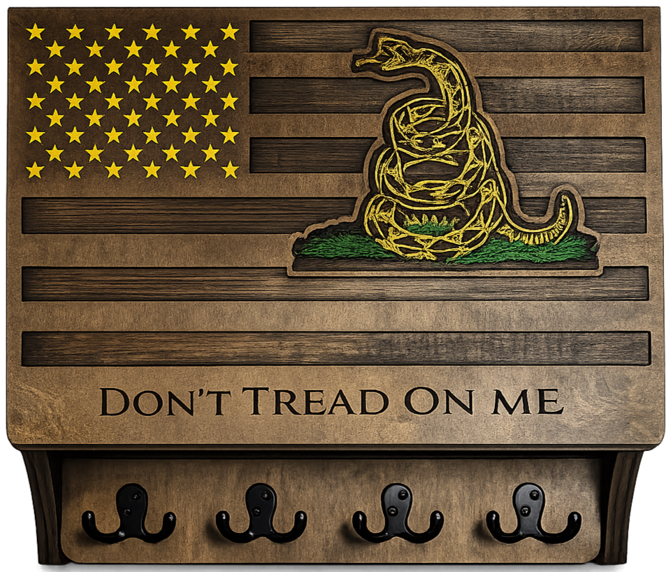 A wooden wall hanging featuring an American flag design with a yellow snake coiled and ready to strike, and the phrase "Don't Tread on Me" underneath. The piece has hooks at the bottom.