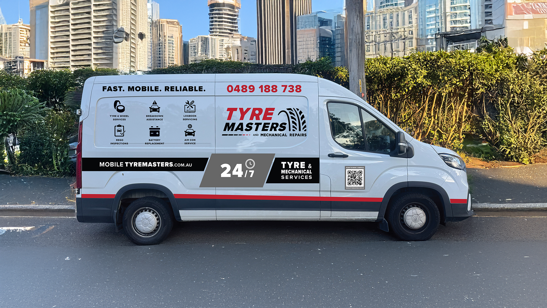 A white van with advertising for Tyre Masters, featuring their logo, contact number, and services such as tyre and wheel services, breakdown assistance, logbook servicing, REGO inspections, battery replacement, and air conditioning service. The van also displays a QR code, website, and 24/7 service label, parked on a city street with tall buildings and greenery in the background.