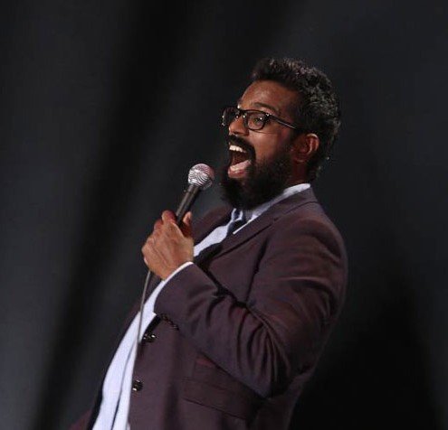 Romesh Ranganathan keynote speaker headshot — comedian and television host