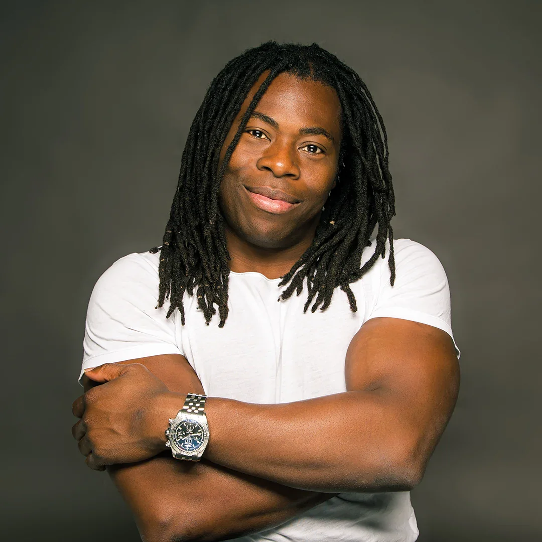 Ade Adepitan MBE, Birmingham City University Chancellor and Paralympic medallist, on stage for 92 Speakers delivering keynotes on the intersection of disability, climate justice, and systemic change.