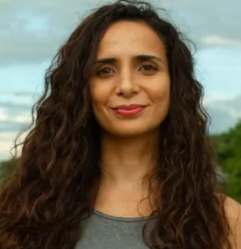 Ella Al-Shamahi, National Geographic Explorer and host of BBC's "Human", on stage for 92 Speakers delivering keynotes on "Becoming Human" and 2026 evolutionary breakthroughs.