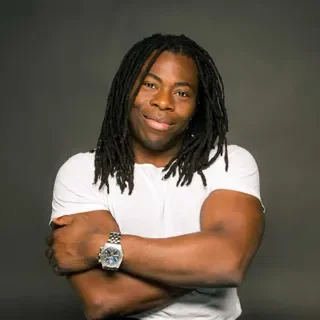 Ade Adepitan MBE, Birmingham City University Chancellor and Paralympic medallist, on stage for 92 Speakers delivering keynotes on the intersection of disability, climate justice, and systemic change.