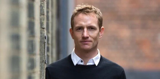 Jon Alexander keynote speaker headshot on citizenship, systems change and purpose-driven leadership
