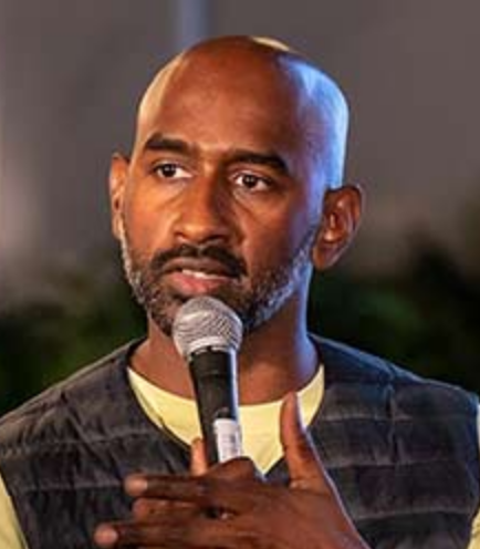 Reuben Christian, founder of Dream Rehab and co-host of What Is This Behaviour?, when delivering keynotes for 92 Speakers on radical humanity and building resilient communities.