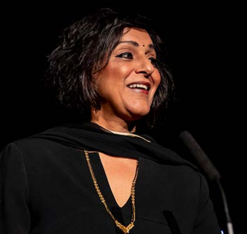 Dame Meera Syal DBE, author of "Anita and Me" and "Vigilauntie", on stage for 92 Speakers delivering keynotes on "The Power of the Punchline" and 2026 inclusive storytelling.