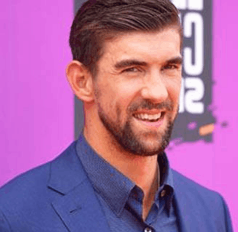 Michael Phelps, the most decorated Olympian of all time, on stage for 92 Speakers delivering keynotes on the "Weight of Gold" and the psychology of high-stakes environments.