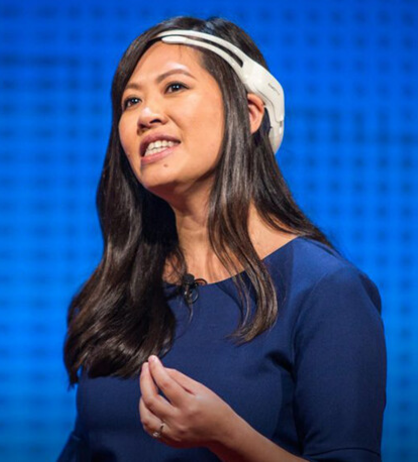 Tan Le speaking on neuroscience, brain-computer interfaces, human–machine interaction and the future of technology at a business conference.