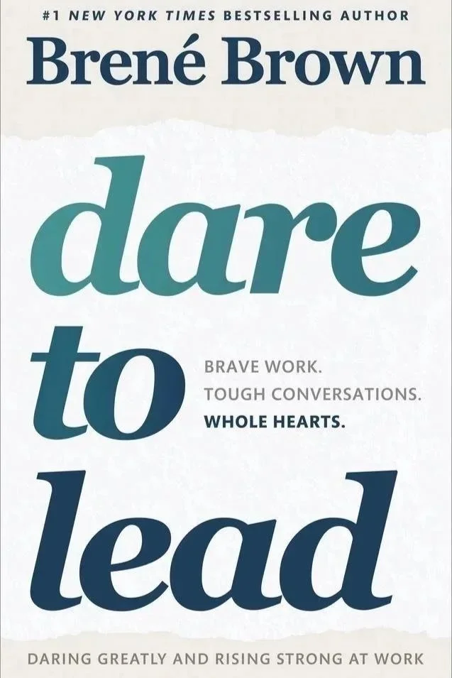 Book cover of 'Dare to Lead' by Brené Brown with bold text in shades of blue and teal, featuring the title, author's name, and a tagline about leadership and courage.