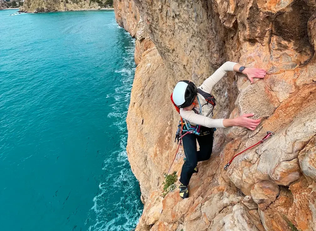 A girl is enjoying a climbing above the see in the Costa Blanca