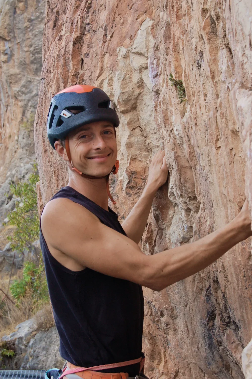 Climbing guide Smiling in Granada, holding warm climbing limestone