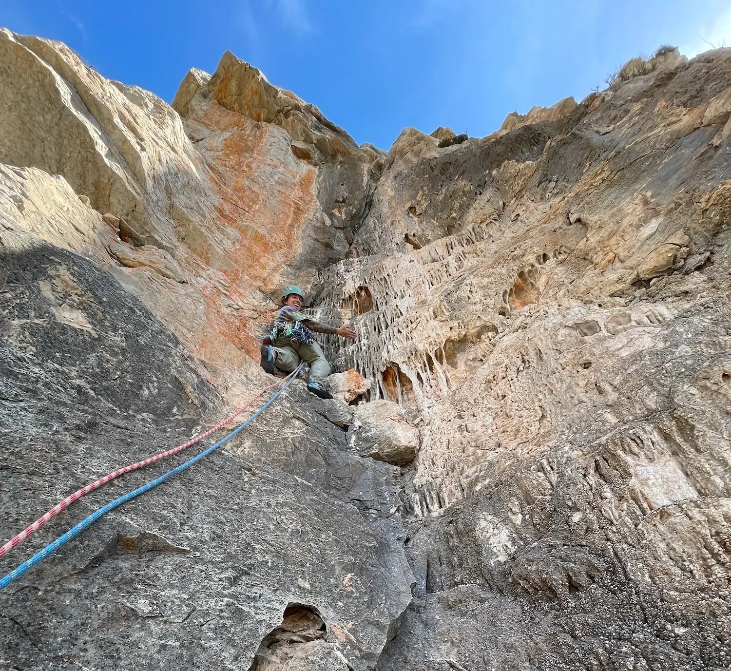 Trad climber climbing her first trad climbing pitch