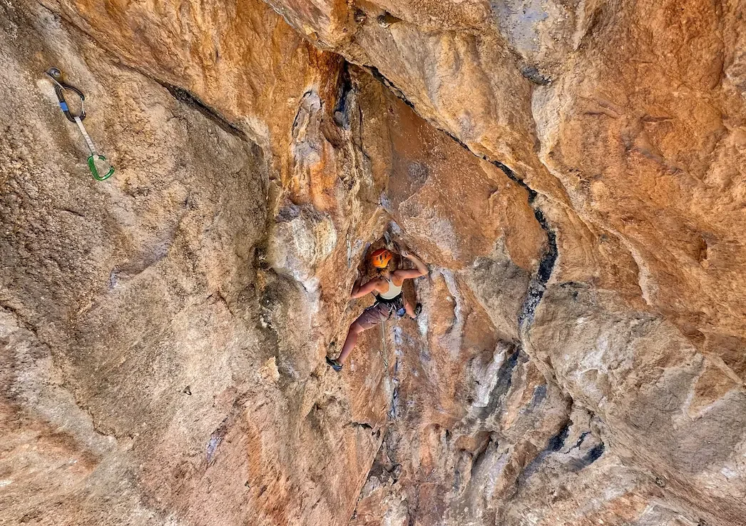 A girl trying her project during an advanced climbing course